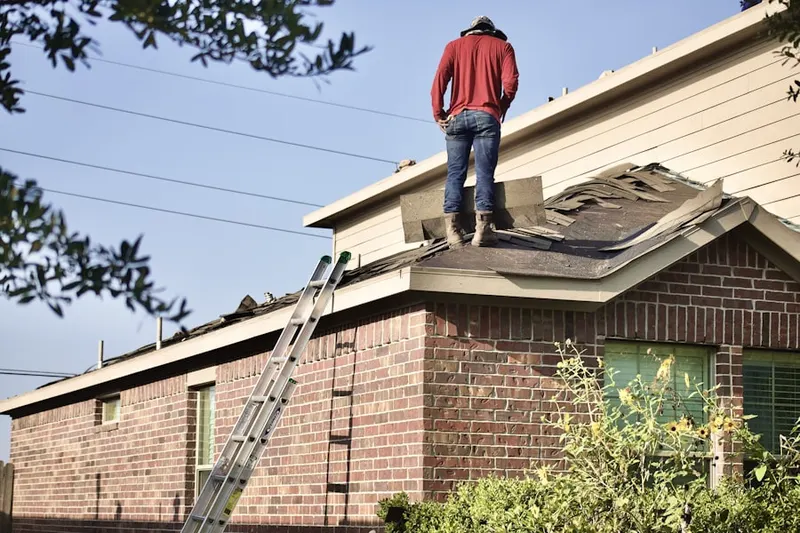 Professional roofer working on a residential roof in Johnstown
